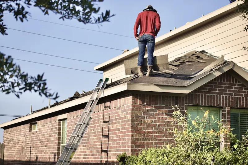 Professional roofer working on a residential roof in Port Penn